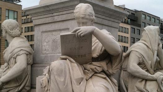 Statues holding books from German authors