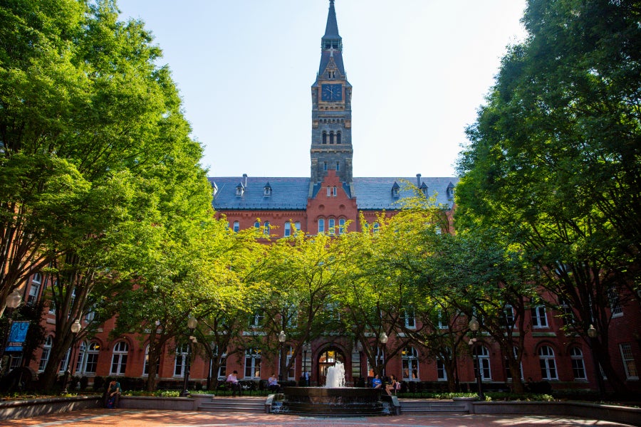 Healy Hall clock and courtyard with trees