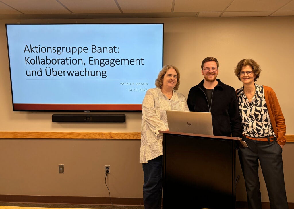 Dr. Dupree, Patrick Graur, and Dr. Eigler stand at a podium after Patrick's lecture.