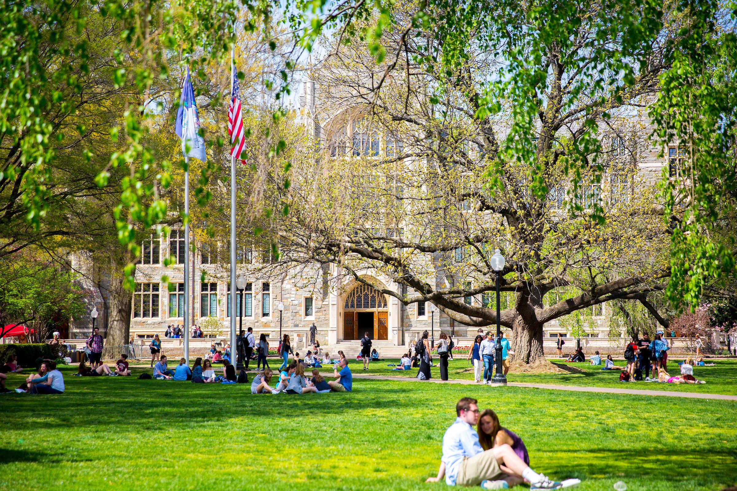 Students sitting on the lawn in front of White Gravenor hall